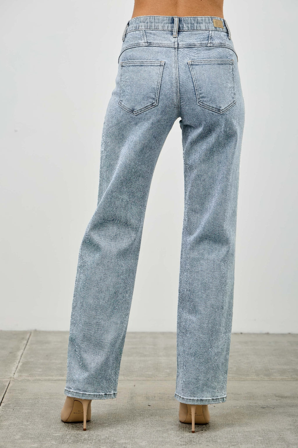Light blue acid-wash jeans on a plain background