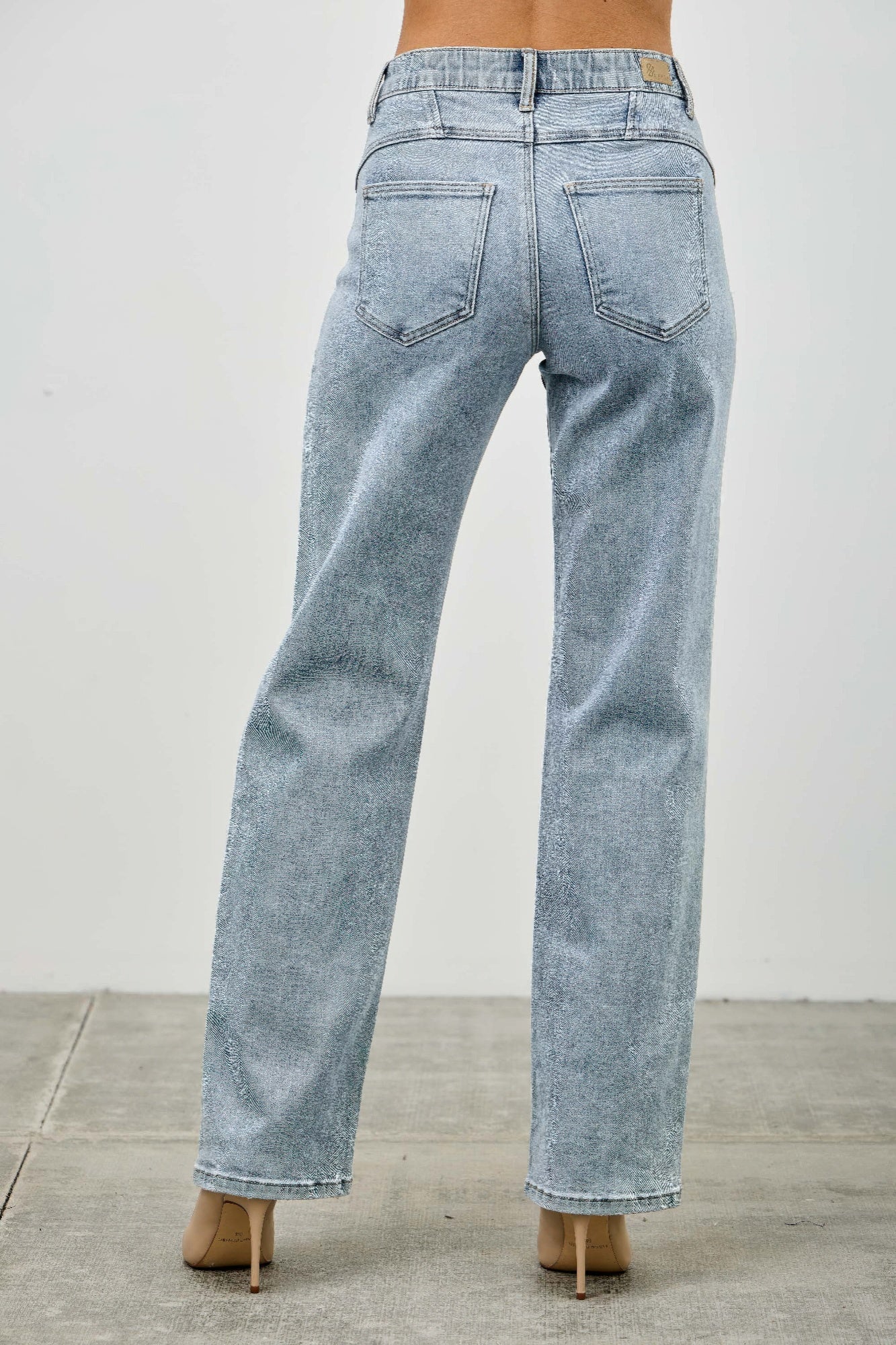 Light blue acid-wash jeans on a plain background